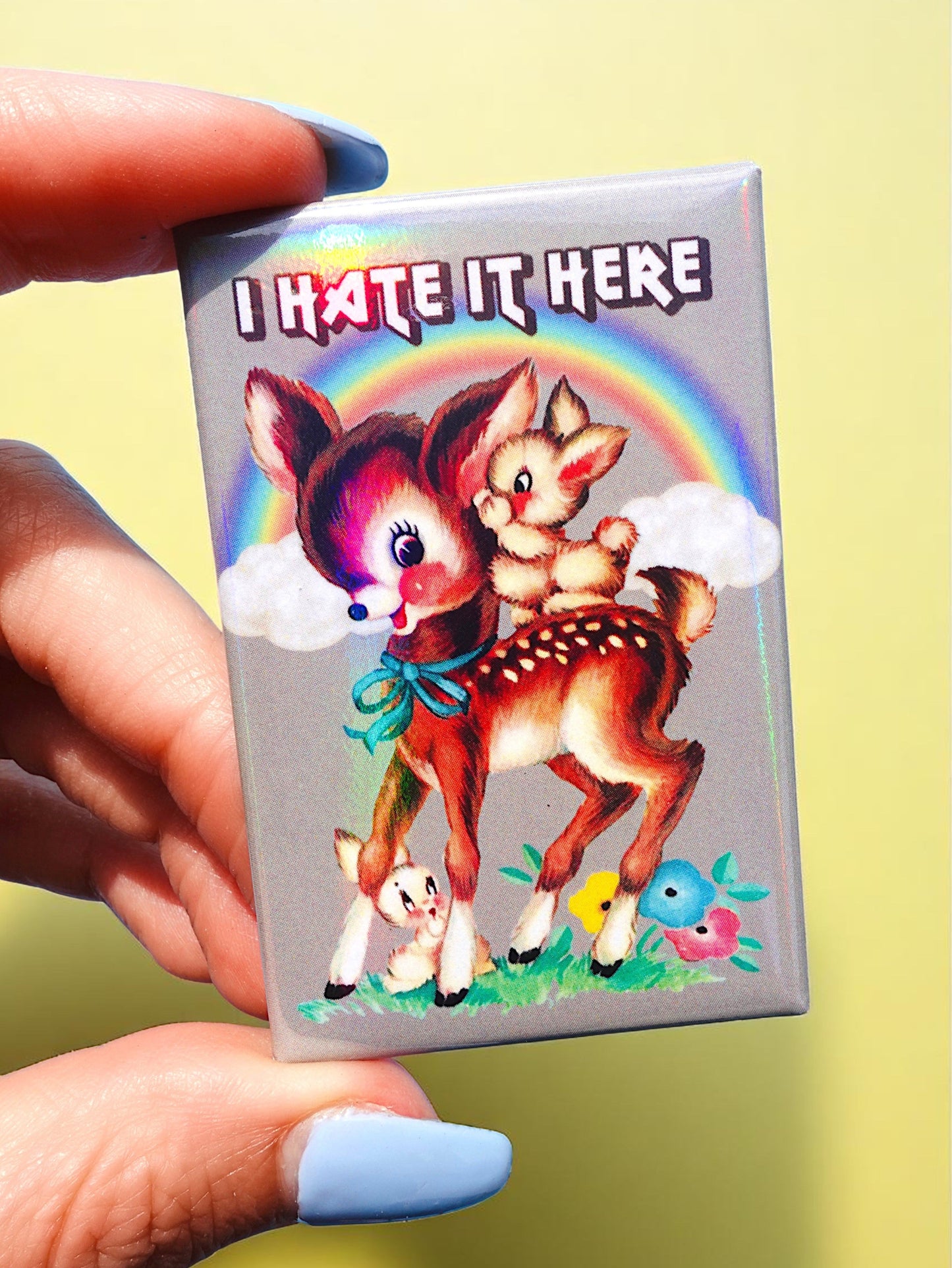 I Hate It Here Holographic Pin – Retro Rainbow Deer with Dark Humor